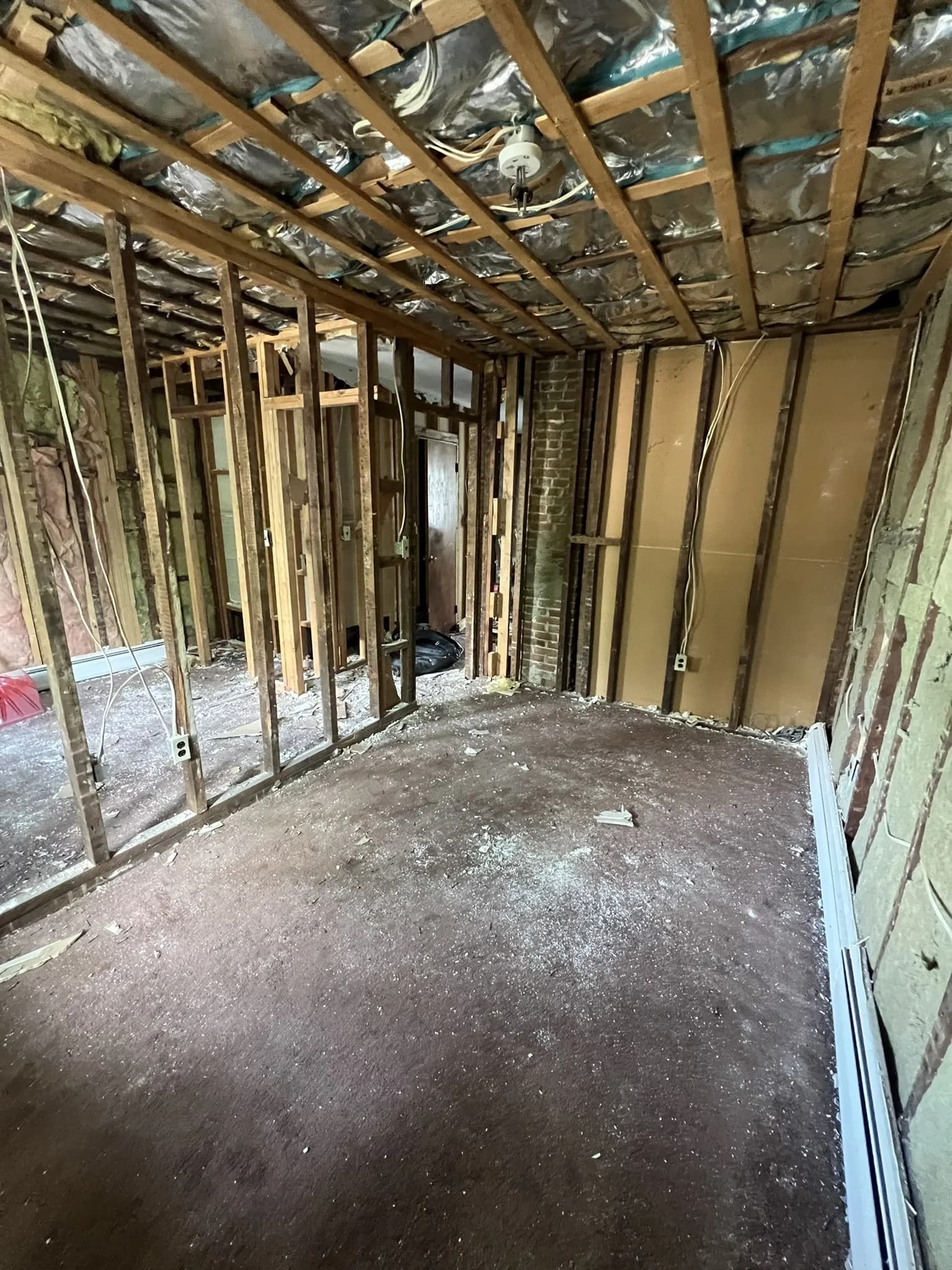 Interior stripped to wall framing during a KNT gut renovation